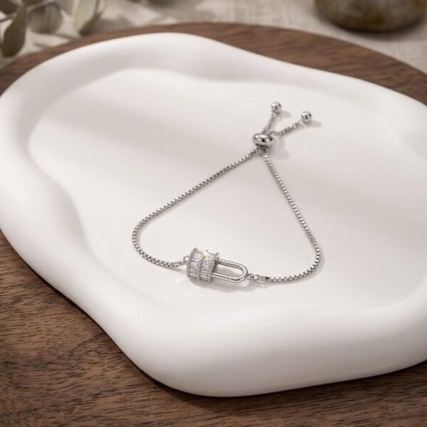 AD Silver Lock Rakhi — silver tone bracelet by Priyavi Creation